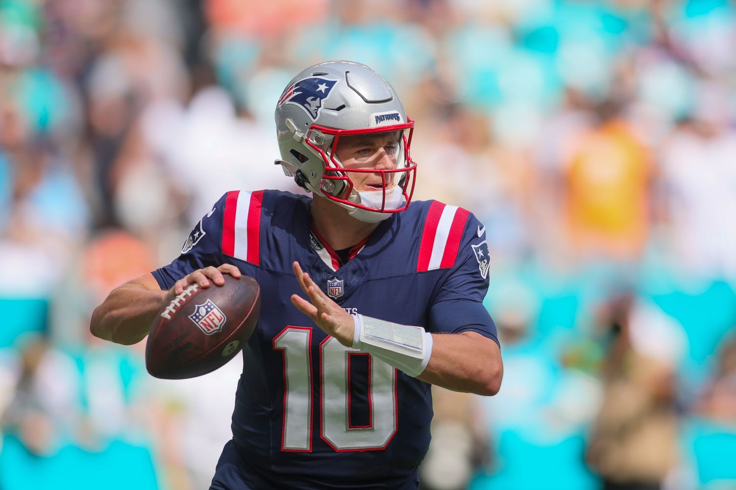 Oct 29, 2023; Miami Gardens, Florida, USA; New England Patriots quarterback Mac Jones (10) looks for a passing option against the Miami Dolphins during the first quarter at Hard Rock Stadium. Mandatory Credit: Sam Navarro-USA TODAY Sports  